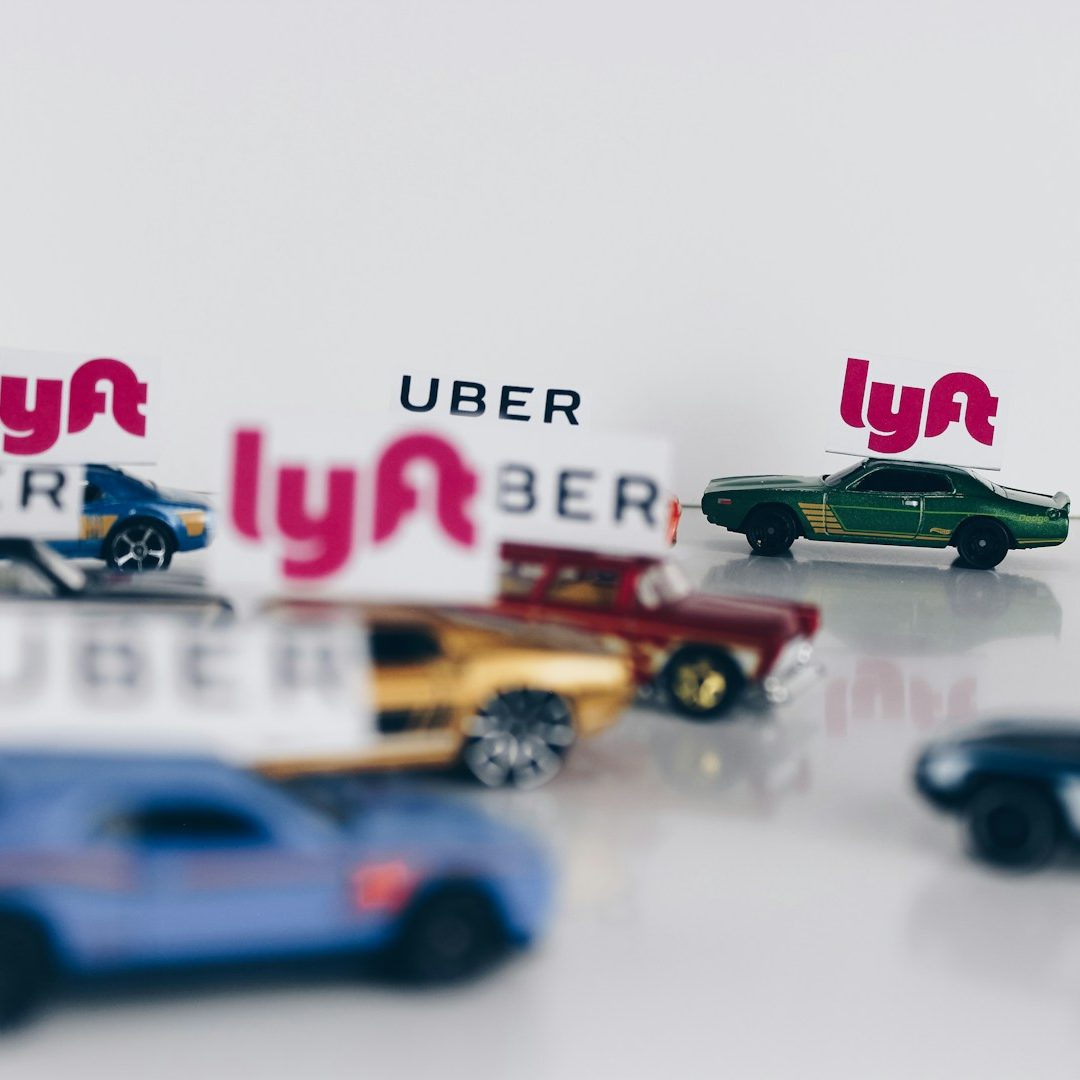 Colorful toy cars with "Uber" and "Lyft" signs on top.